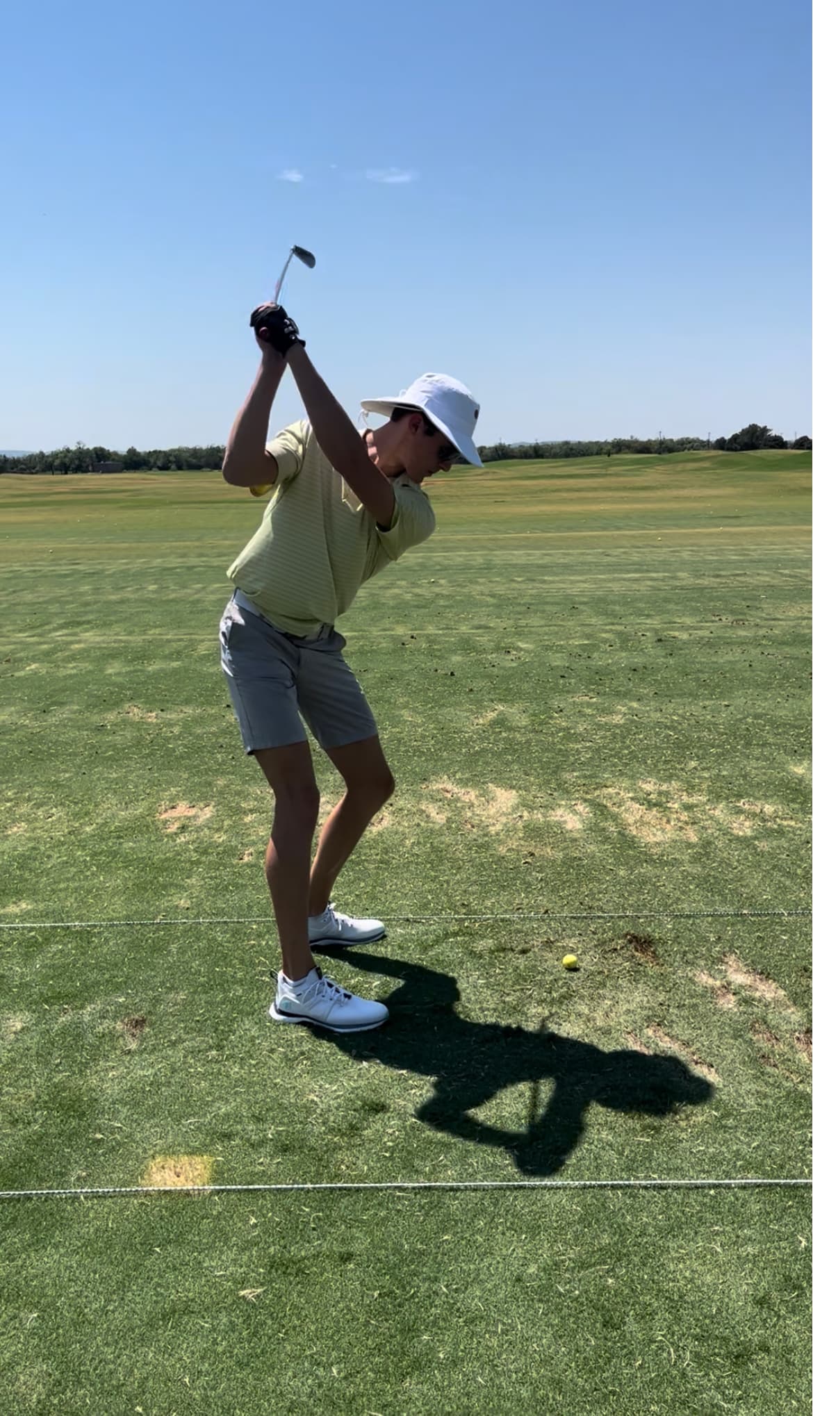 Turner mid-swing at the golf range