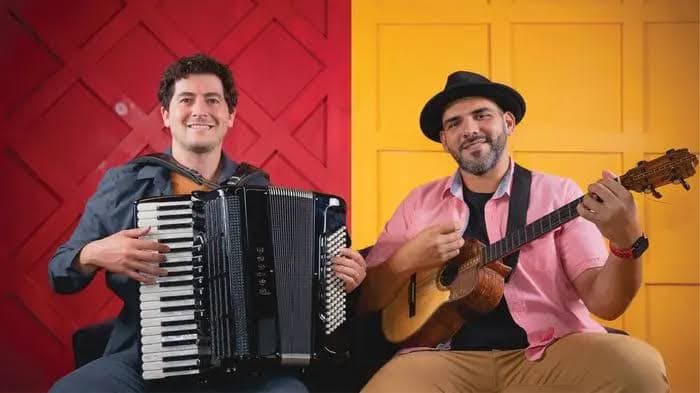 Sam Reider playing accordion and Jorge Glem playing cuatro